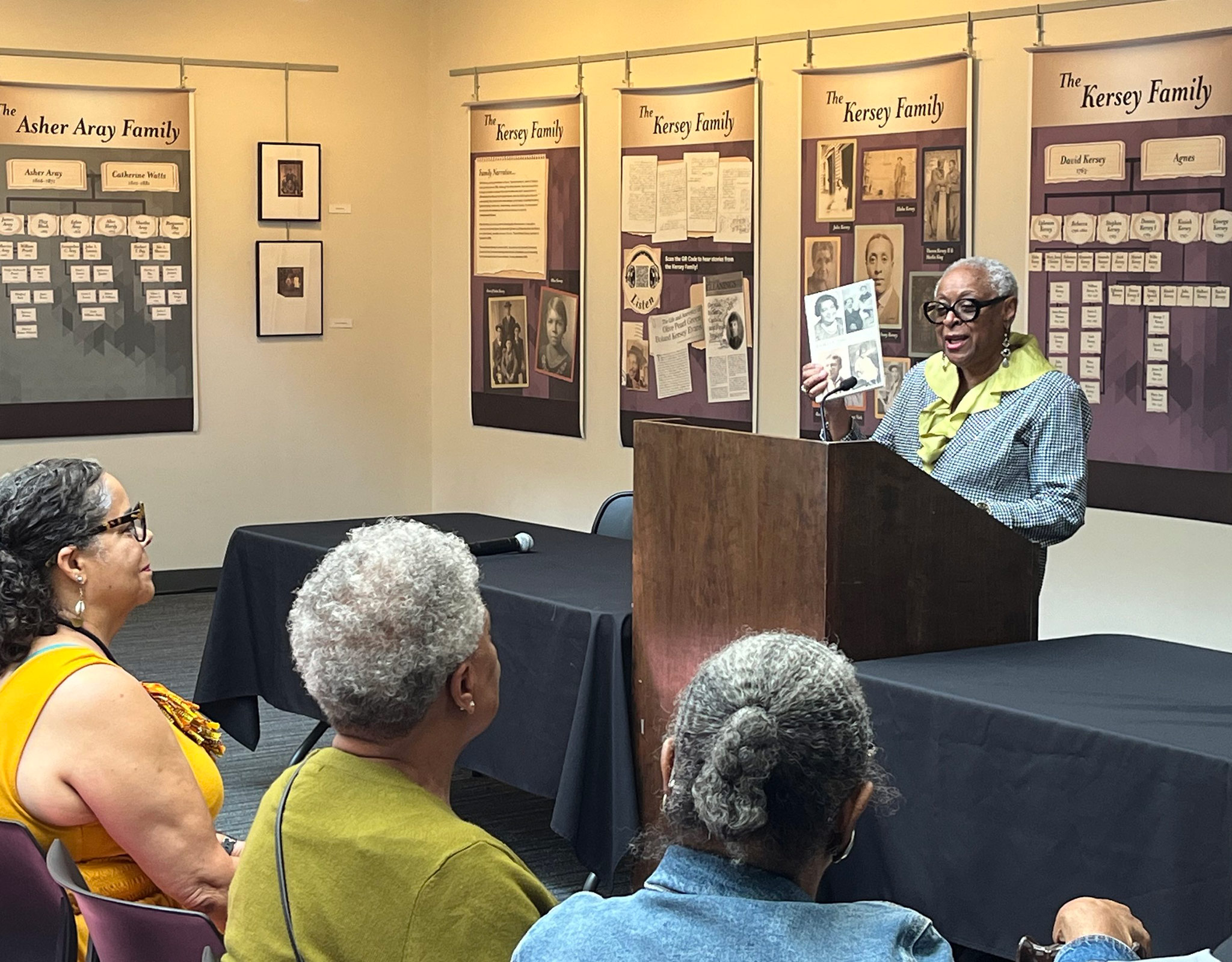A photo of Joyce Hunter speaking at the Black Washtenaw County Collaboratory exhibit opening in 2024.