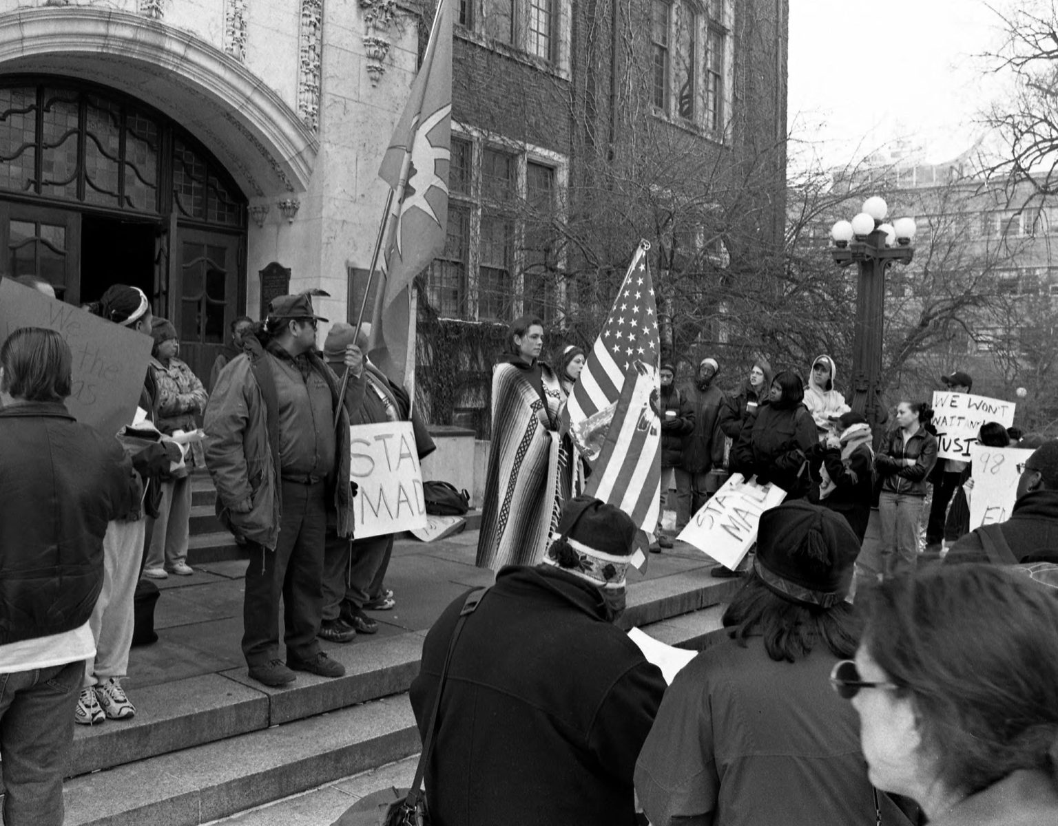 A photo of students protesting against the Michigamua Senior Society at the front entrance of the Michigan Union in 2000.