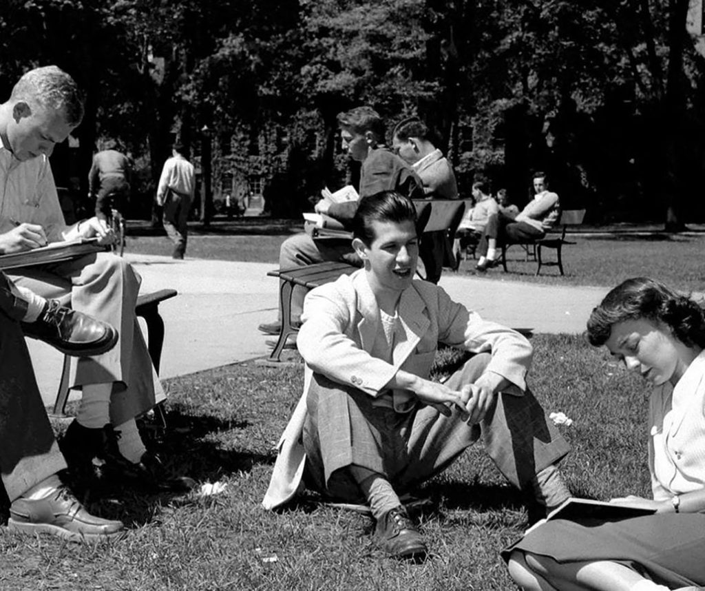 A photo of students studying on the lawn of the University of Michigan Law Quad.
